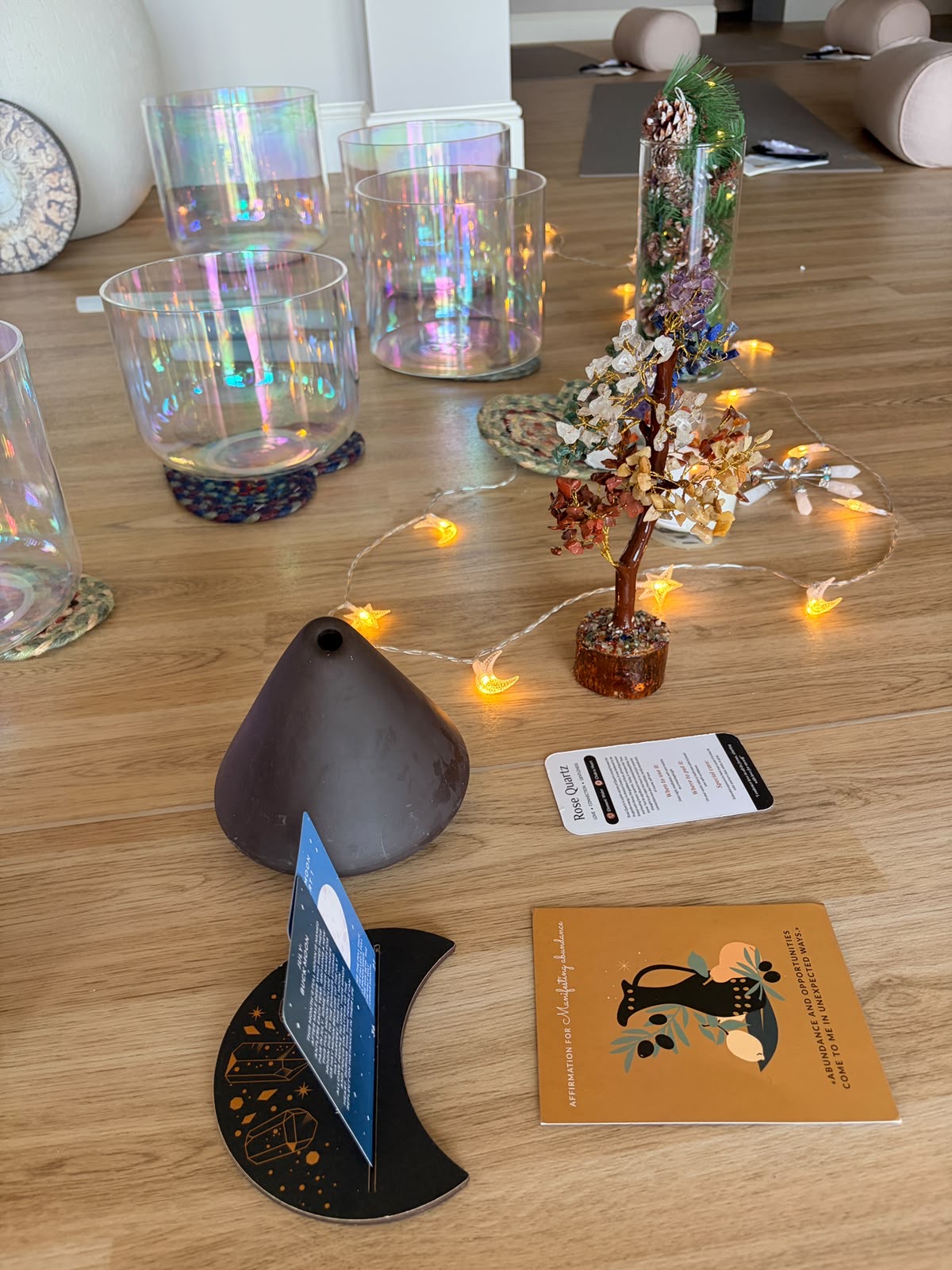An affirmation card resting beside a crystal, set out for a session