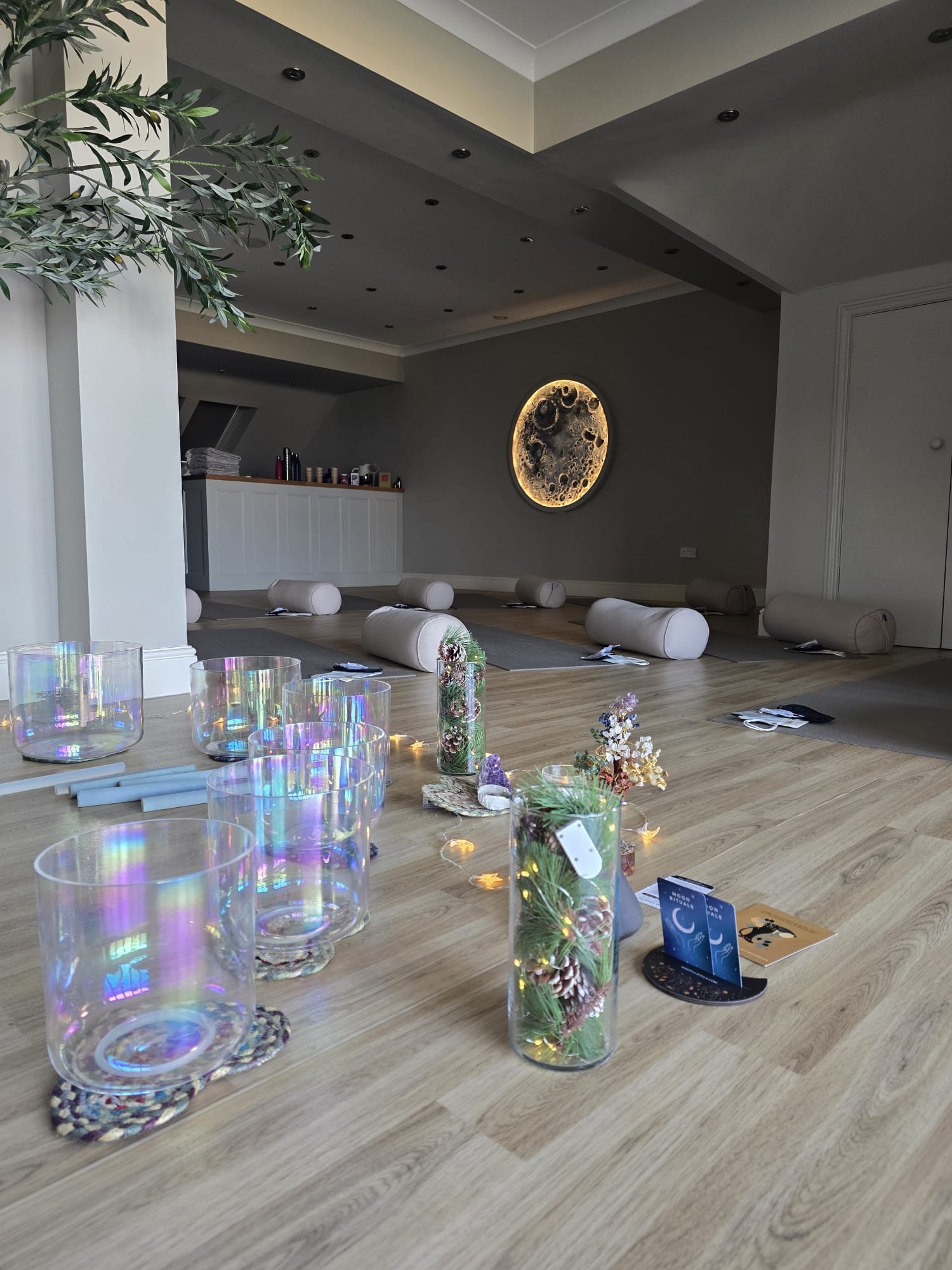 Crystal singing bowls arranged beneath a glowing moon light