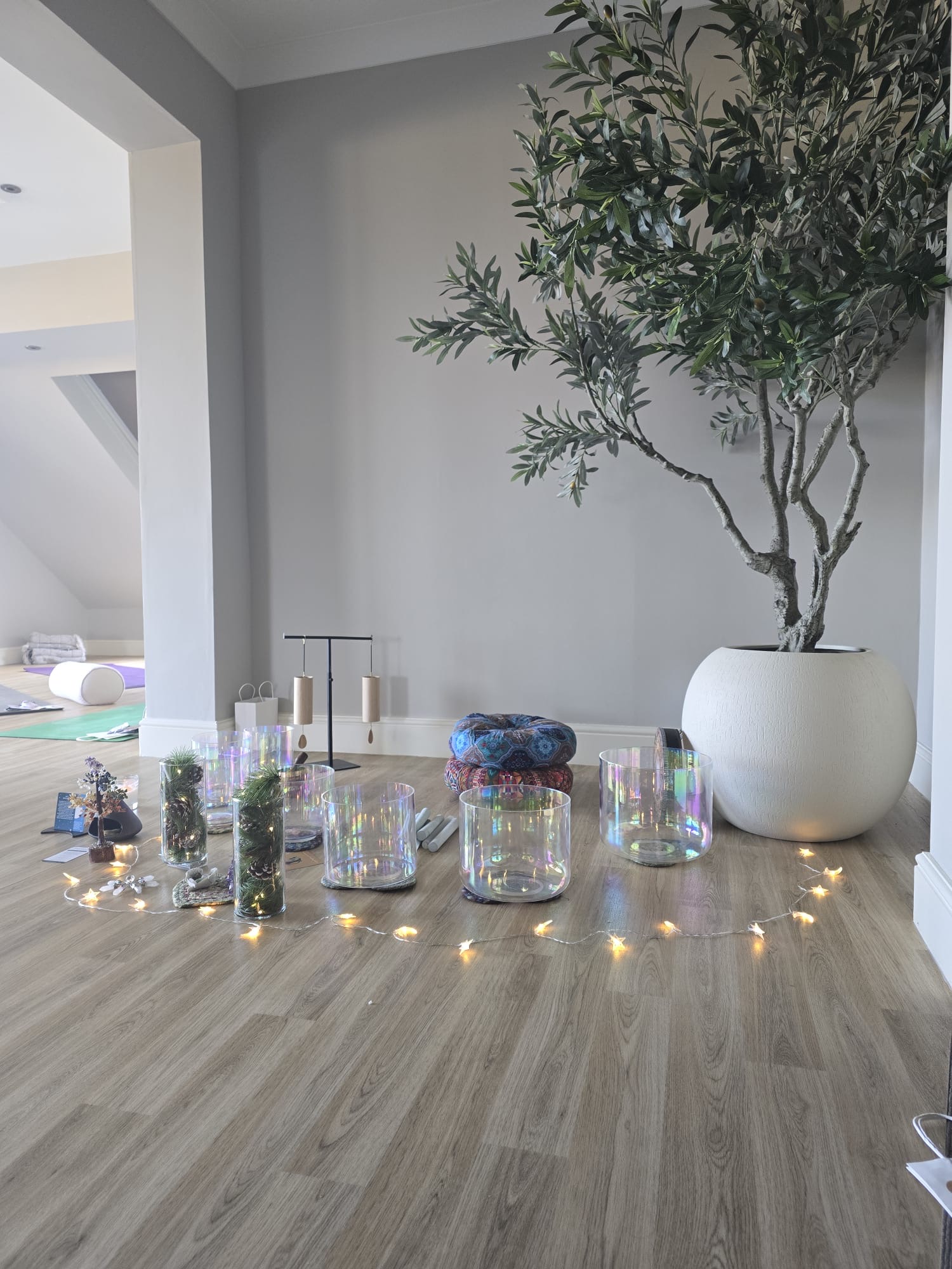 Wide view of the studio with crystal singing bowls laid out on the floor